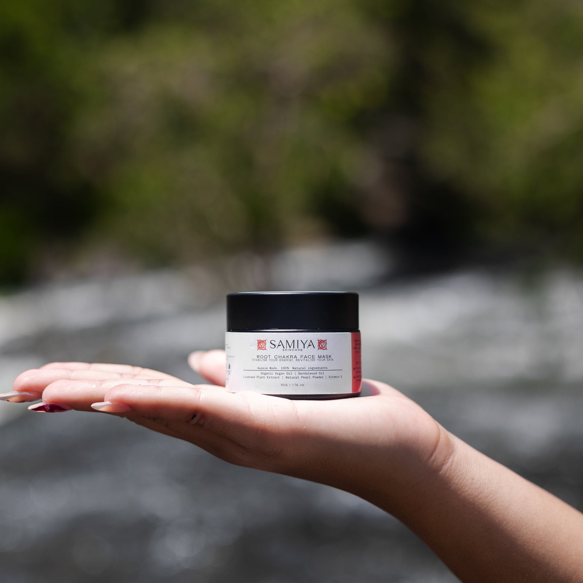 girl holding root chakra face mask