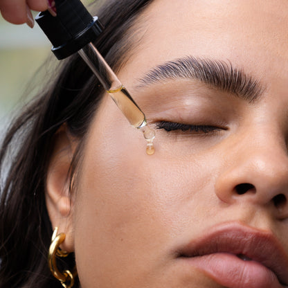 girl putting drop of luxurious oil on face